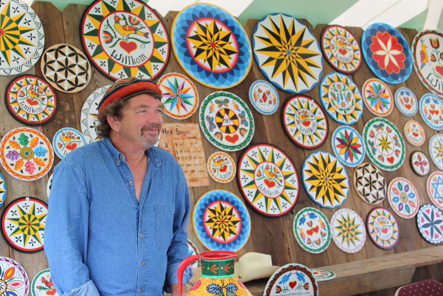 Eric Claypoole with his hex symbols at the 70th annual Kutztown Folk Festival.jpg
